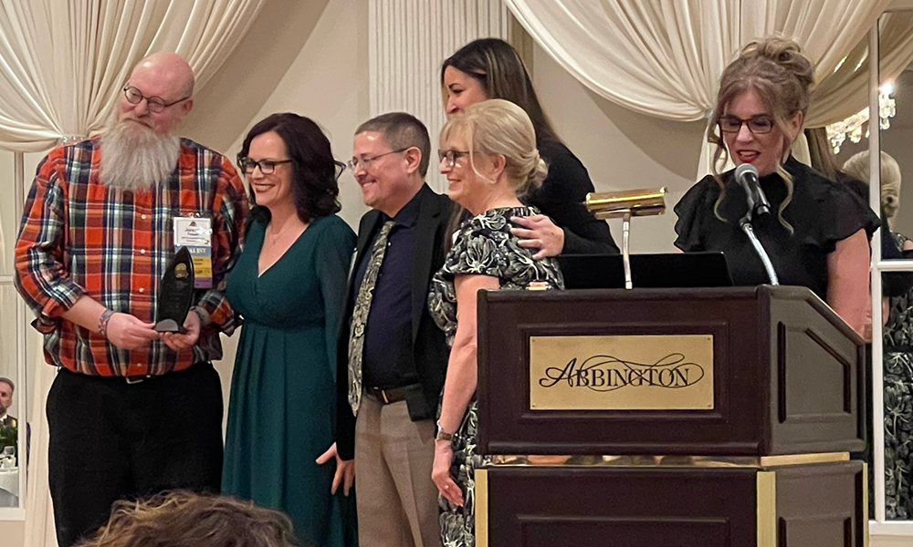 Company Cultuer award being accepted by Jeremy, Emily, and Tim